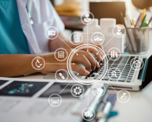 Doctor working on laptop computer and medical stethoscope on clipboard on desk, electronics medical record system EMRs concept