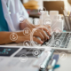 Doctor working on laptop computer and medical stethoscope on clipboard on desk, electronics medical record system EMRs concept