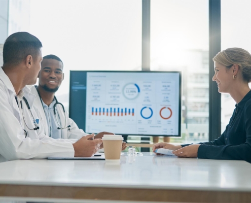 Medical professionals looking at data in meeting