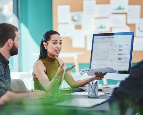 Workers in meeting discussing data management